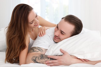 Happy couple spending time together on bed at home