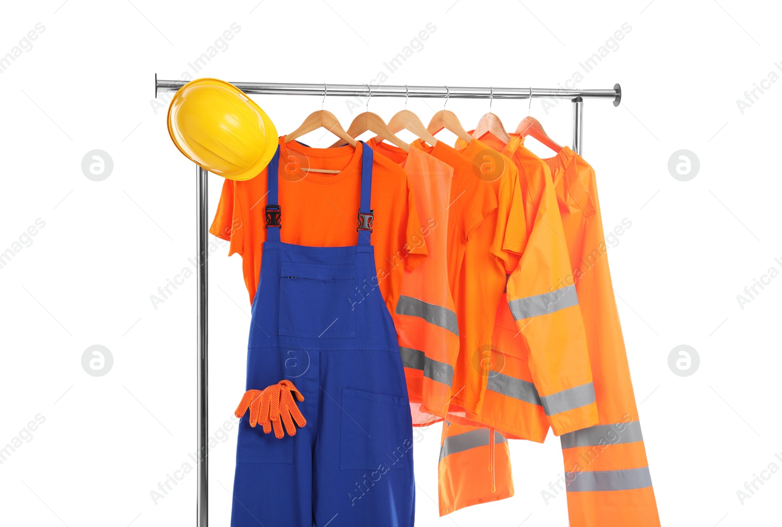 Photo of Workers' uniforms on clothing rack isolated on white