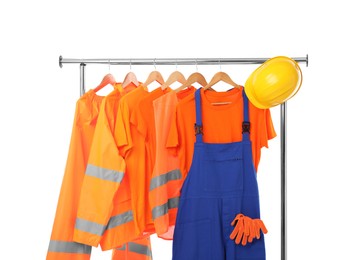 Workers' uniforms on clothing rack isolated on white