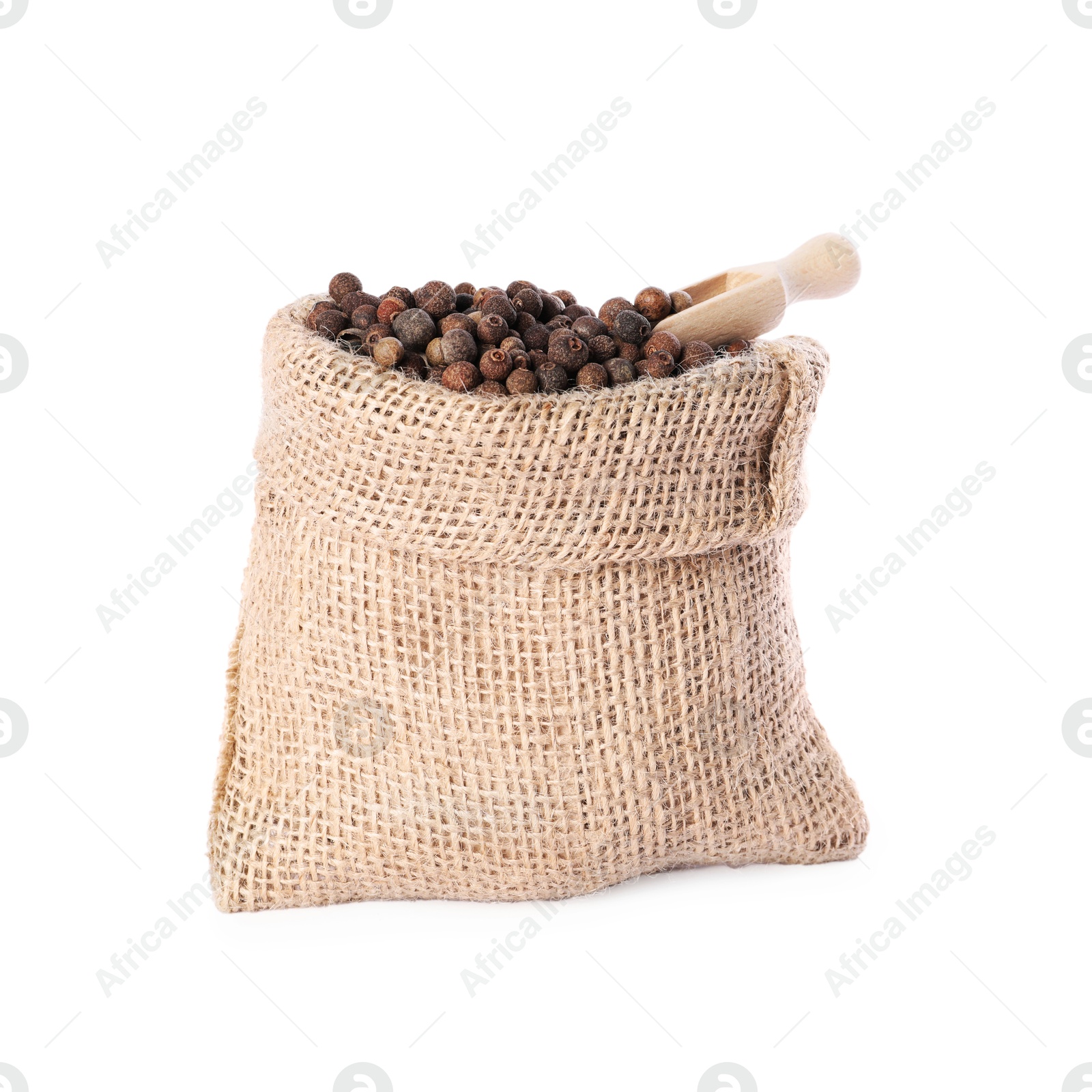 Photo of Burlap sack with allspice and scoop isolated on white