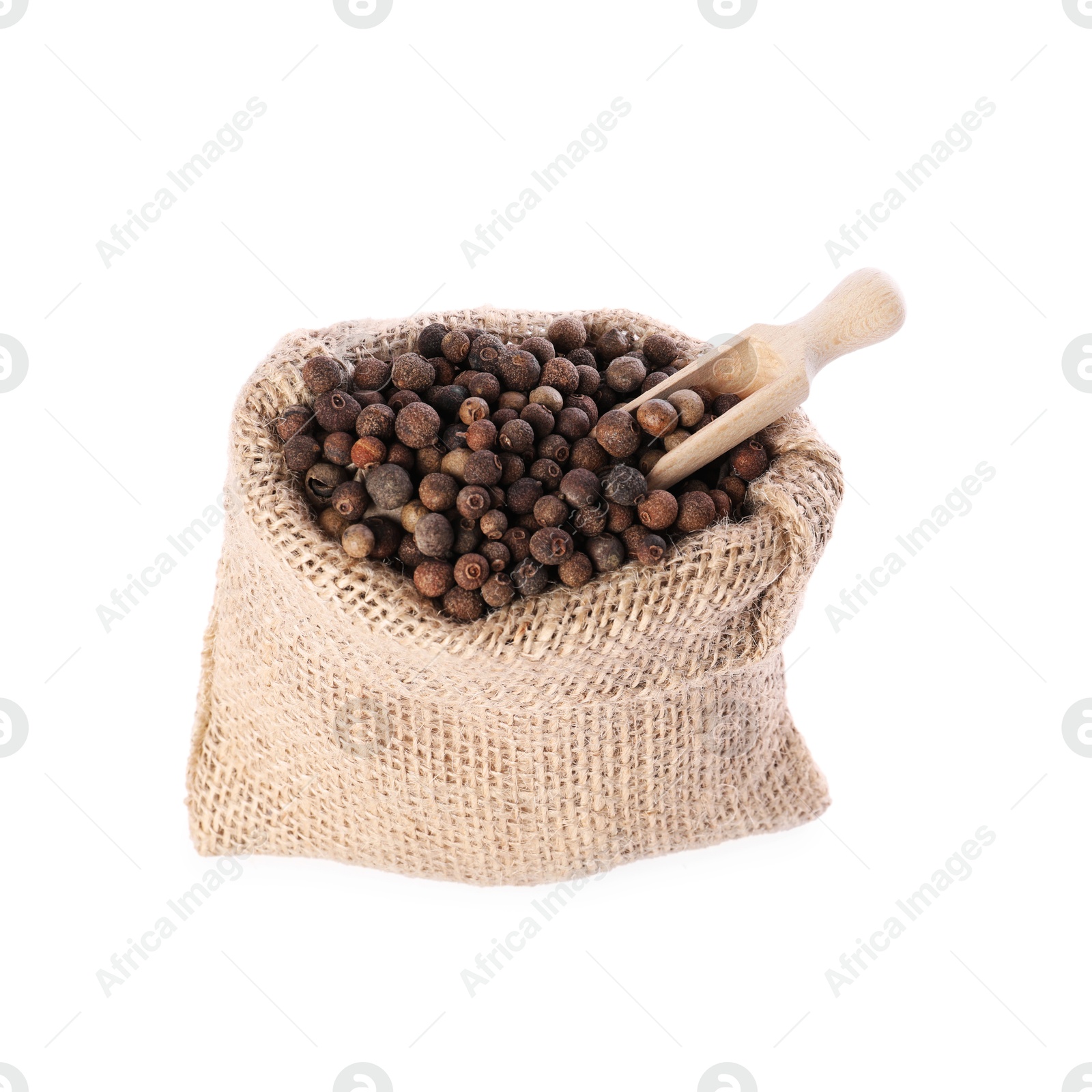 Photo of Burlap sack with allspice and scoop isolated on white