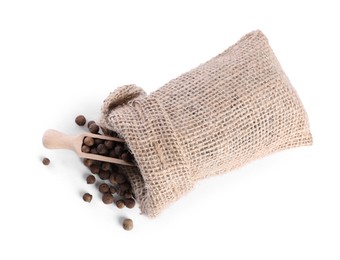 Burlap sack with allspice and scoop isolated on white, top view