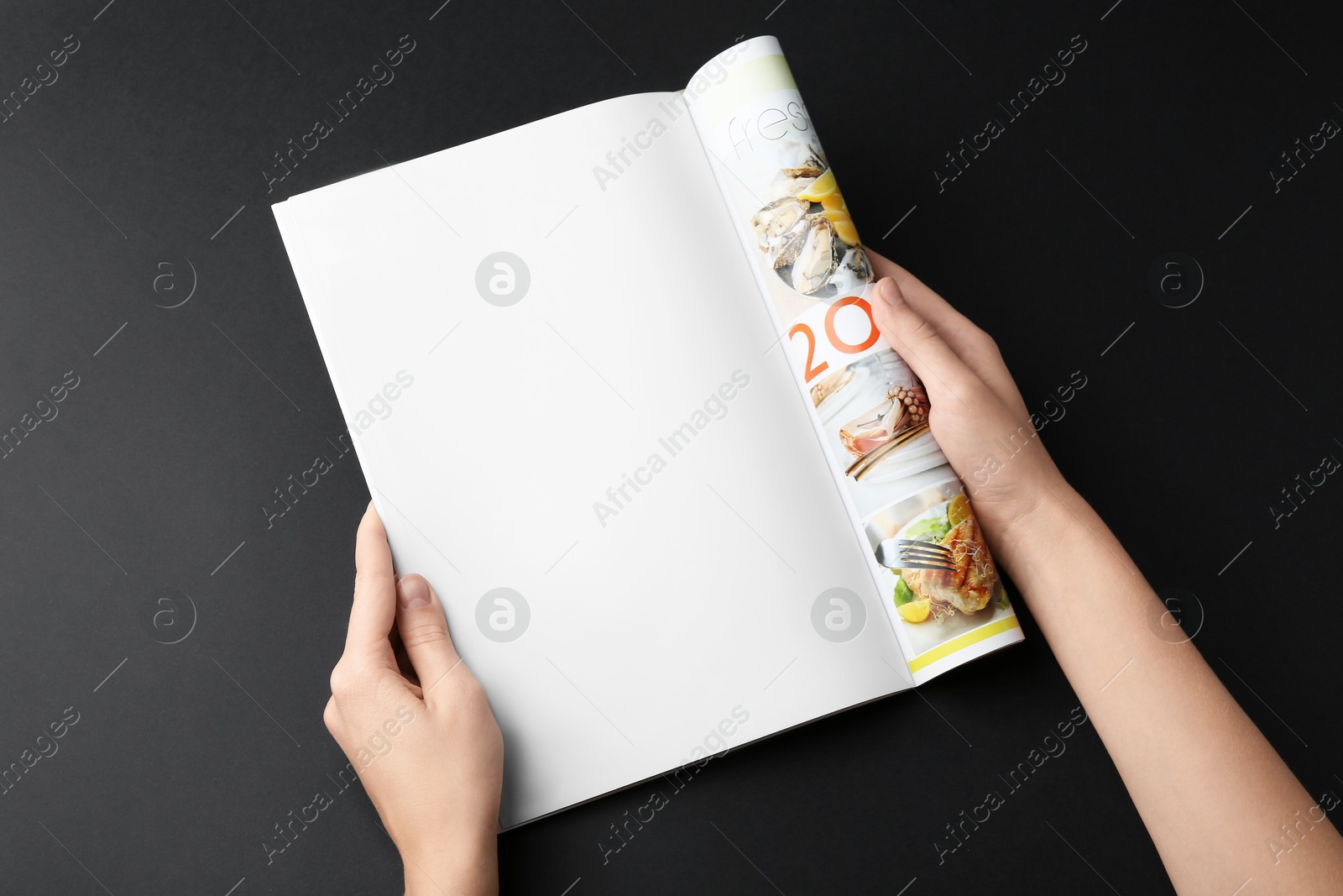 Photo of Woman reading magazine on black background, closeup. Mockup for design