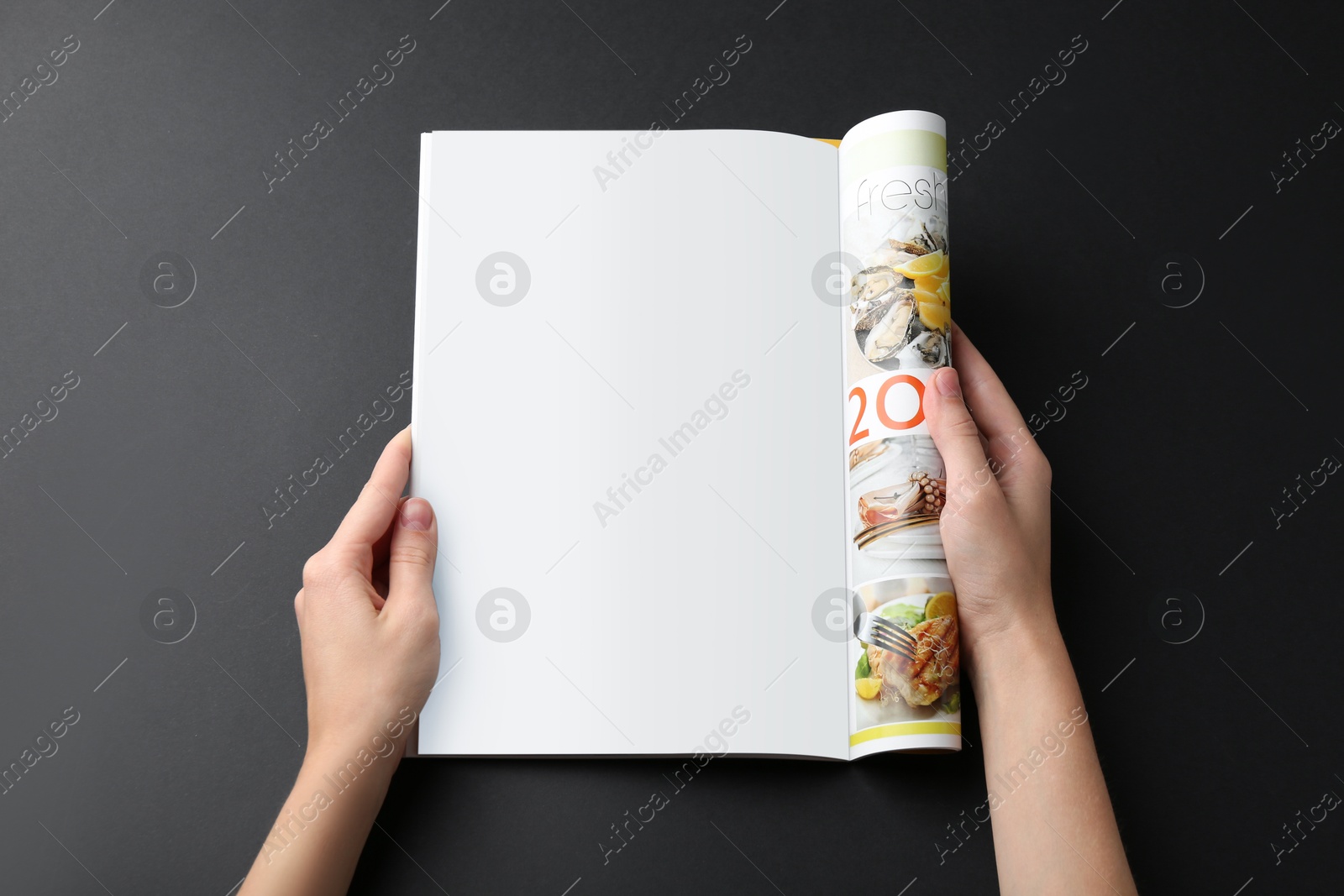 Photo of Woman reading magazine on black background, closeup. Mockup for design