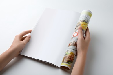 Photo of Woman reading magazine on white background, closeup. Mockup for design