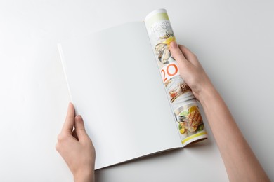 Woman reading magazine on white background, closeup. Mockup for design