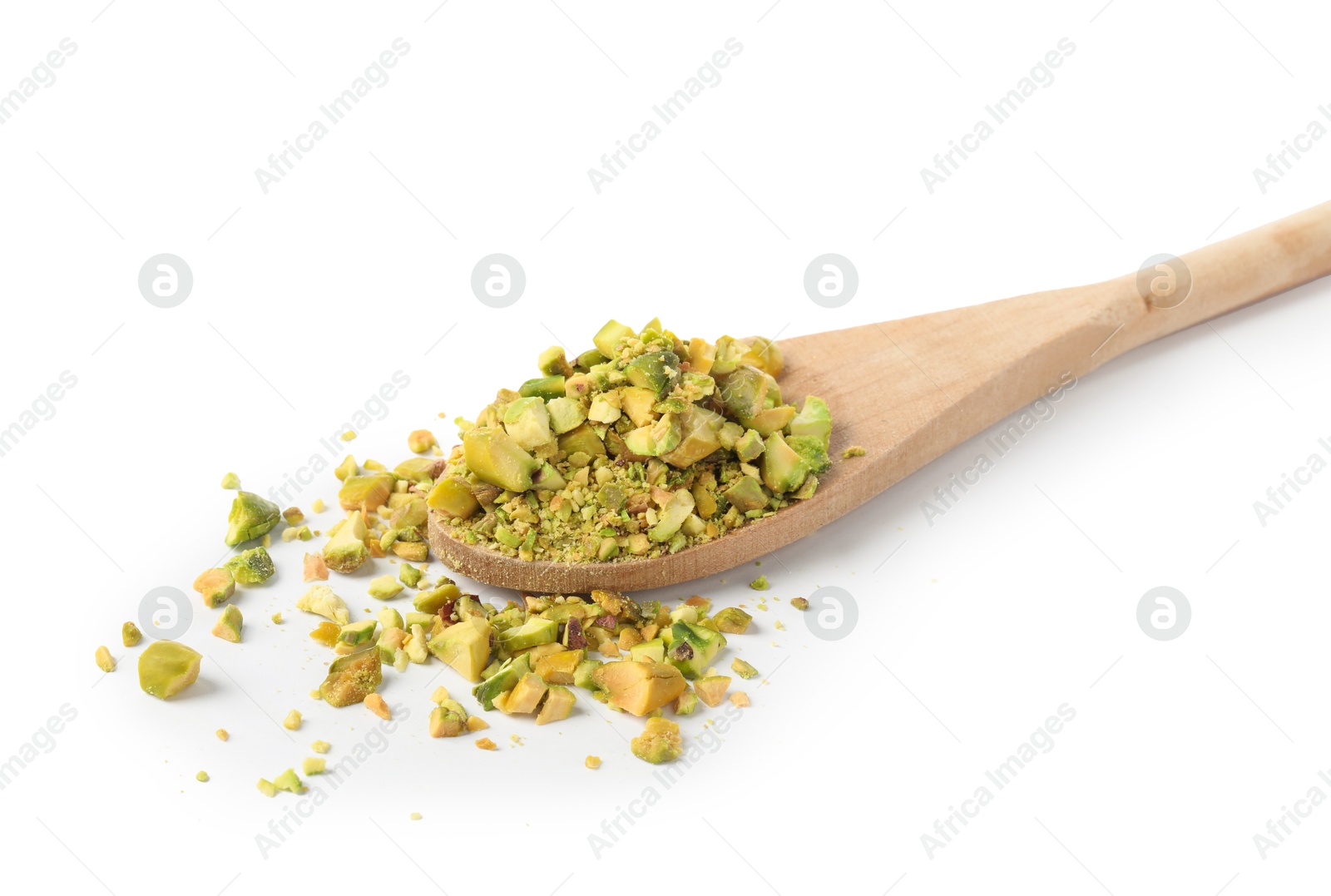 Photo of Pieces of peeled pistachio nut in wooden spoon isolated on white