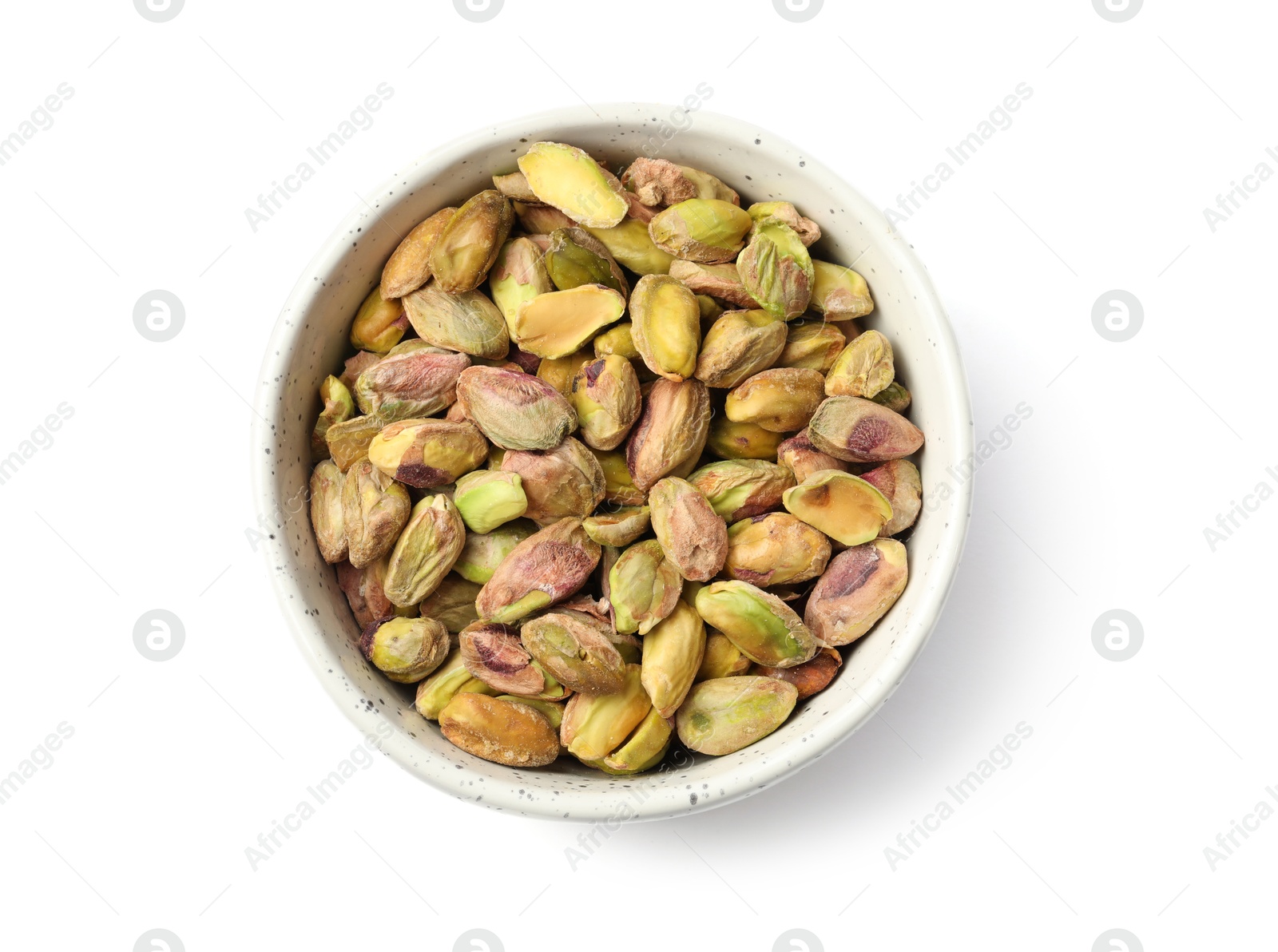 Photo of Peeled pistachio nuts in bowl isolated on white, top view