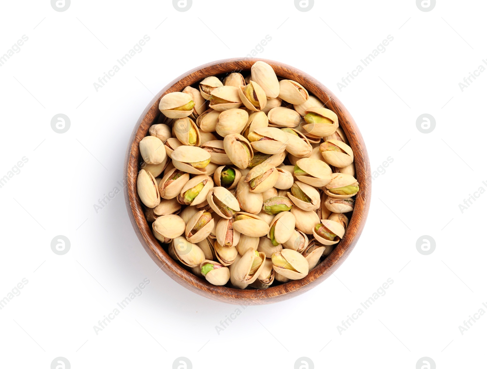 Photo of Tasty pistachio nuts in bowl isolated on white, top view