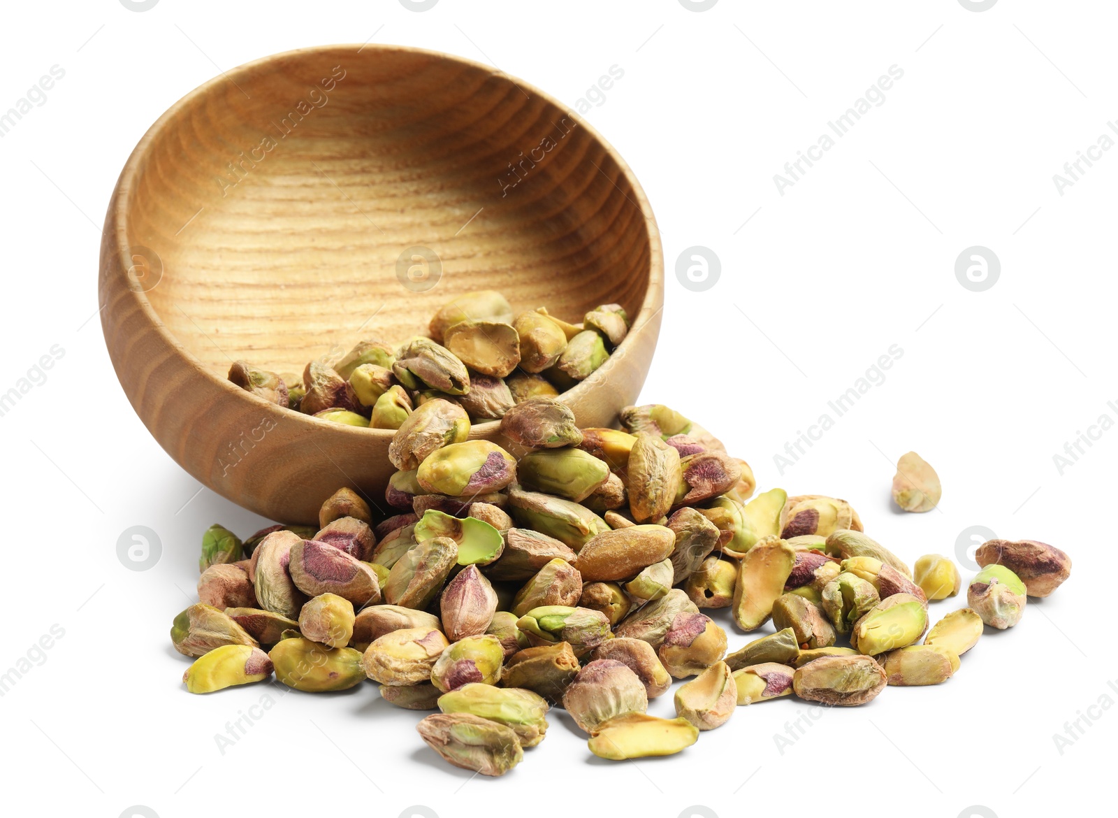 Photo of Peeled pistachio nuts and bowl isolated on white