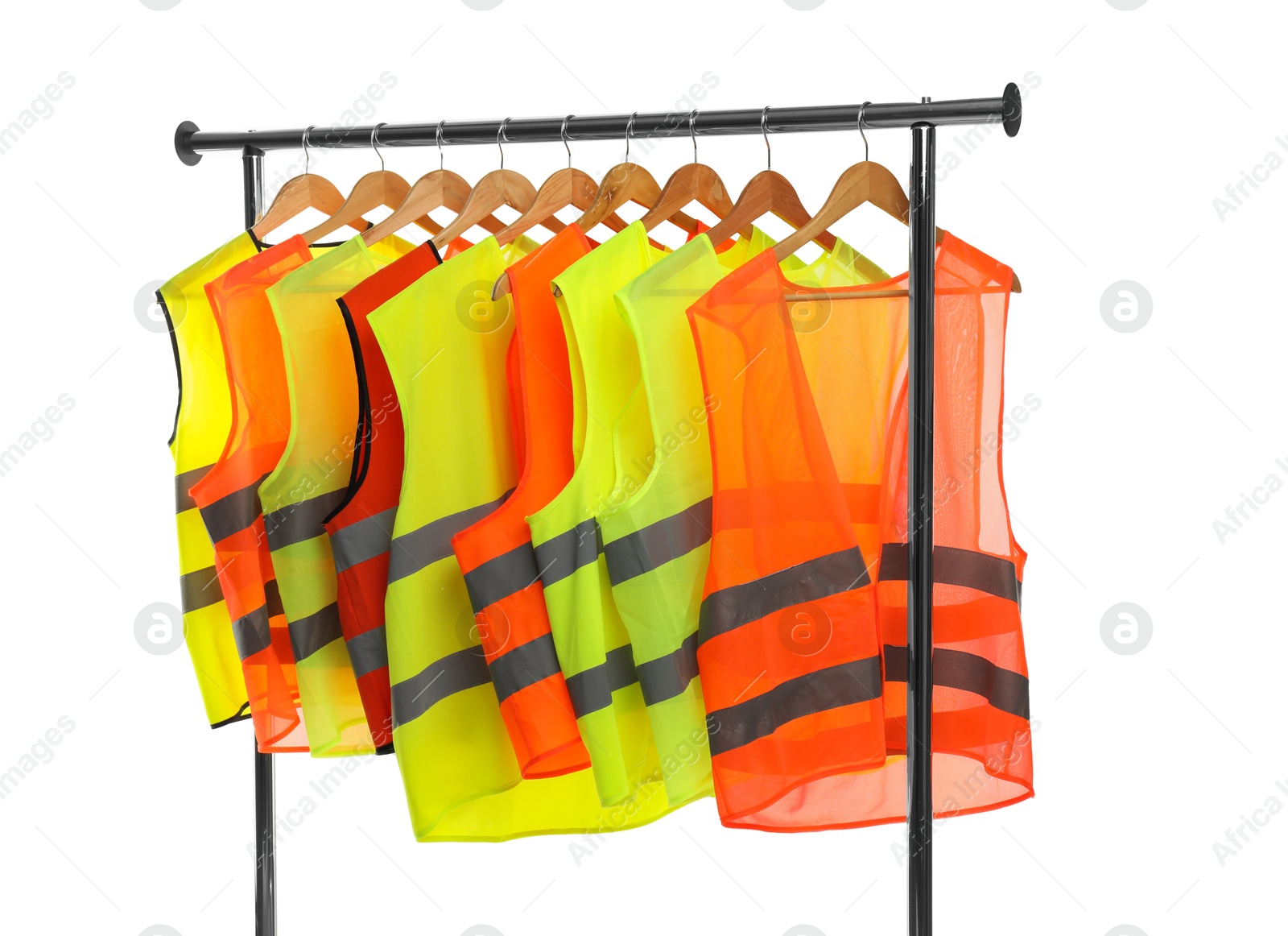 Photo of Different bright reflective vests on clothing rack isolated on white