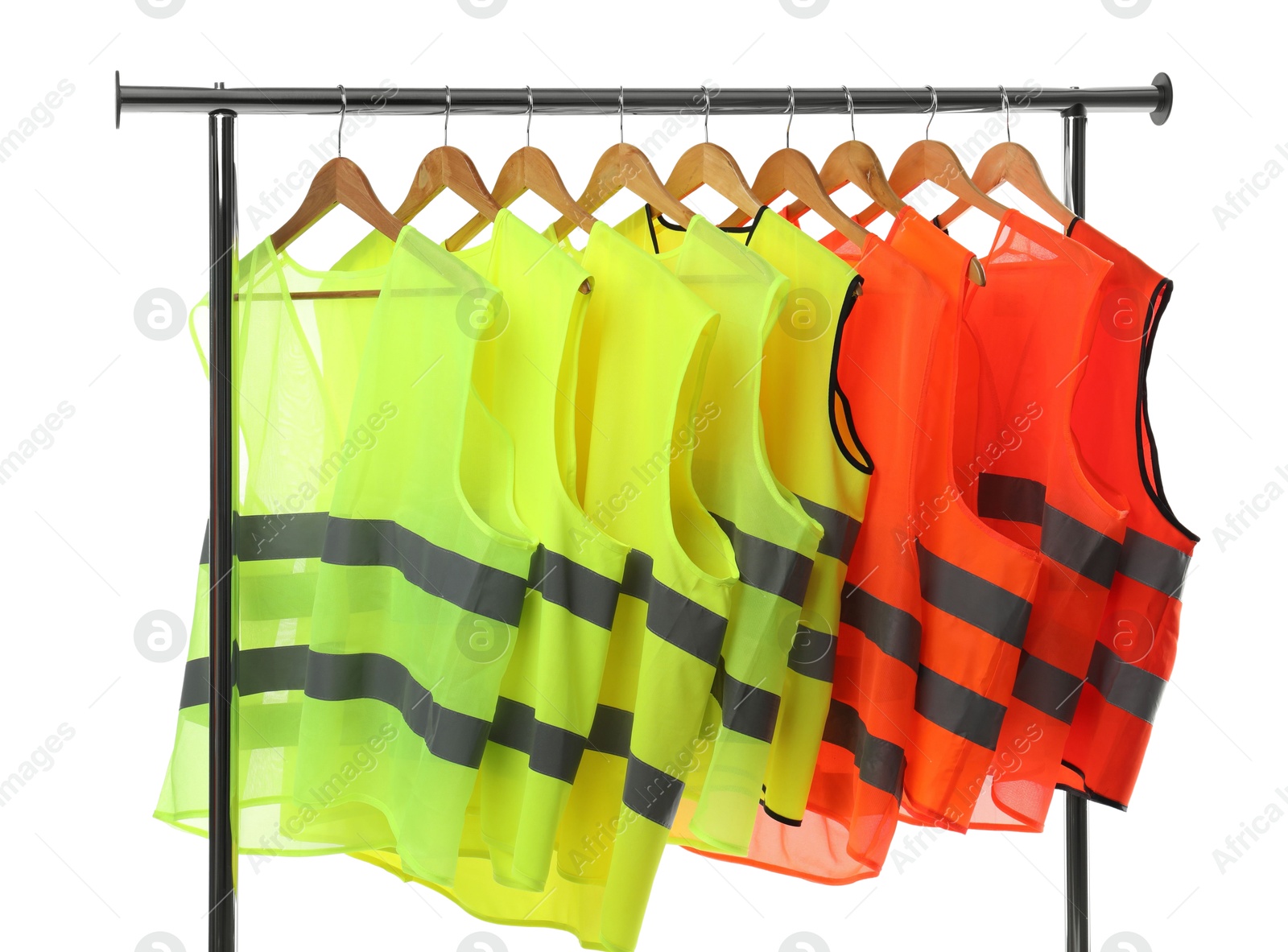 Photo of Different bright reflective vests on clothing rack isolated on white