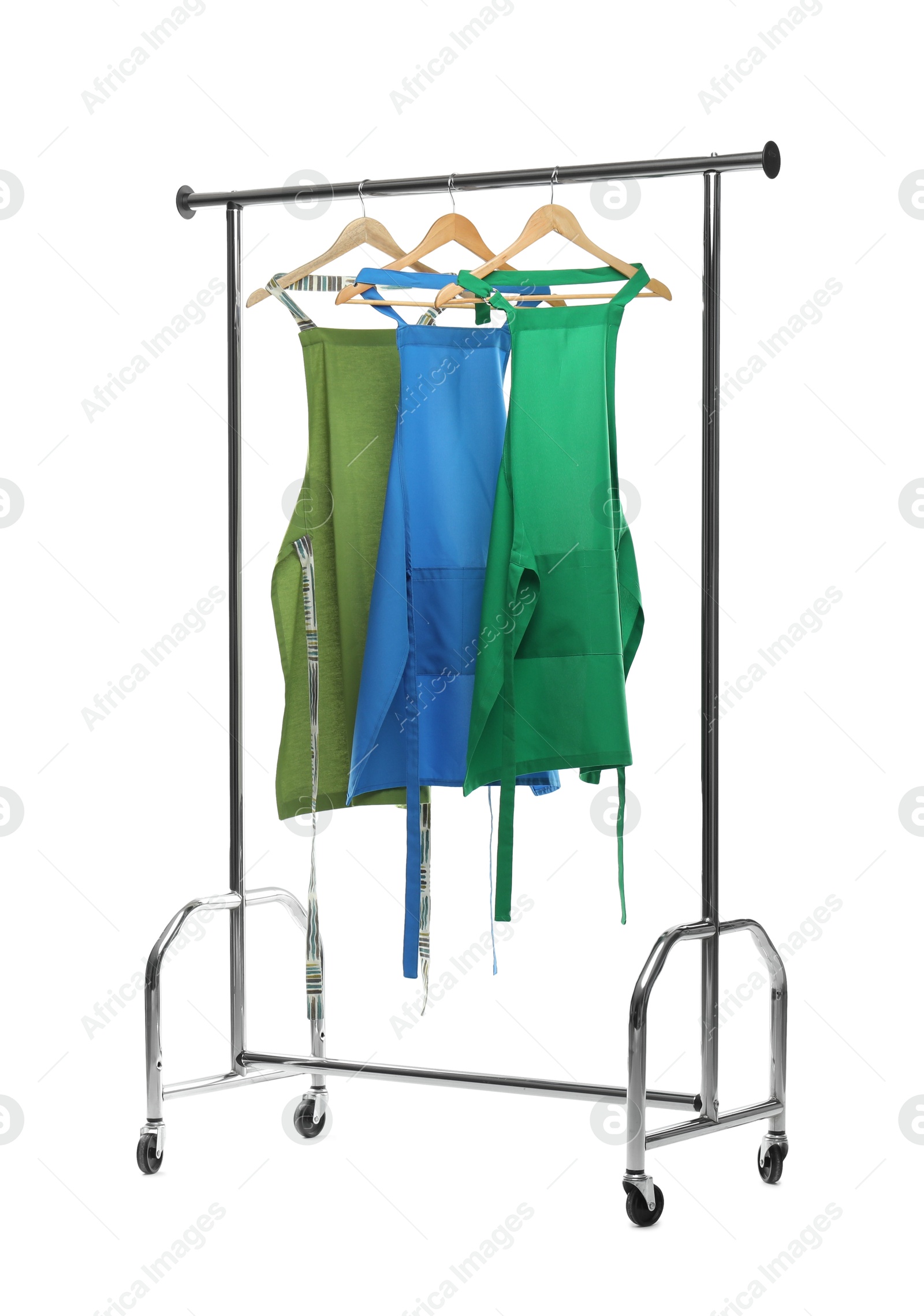 Photo of Chef's aprons on clothing rack isolated on white