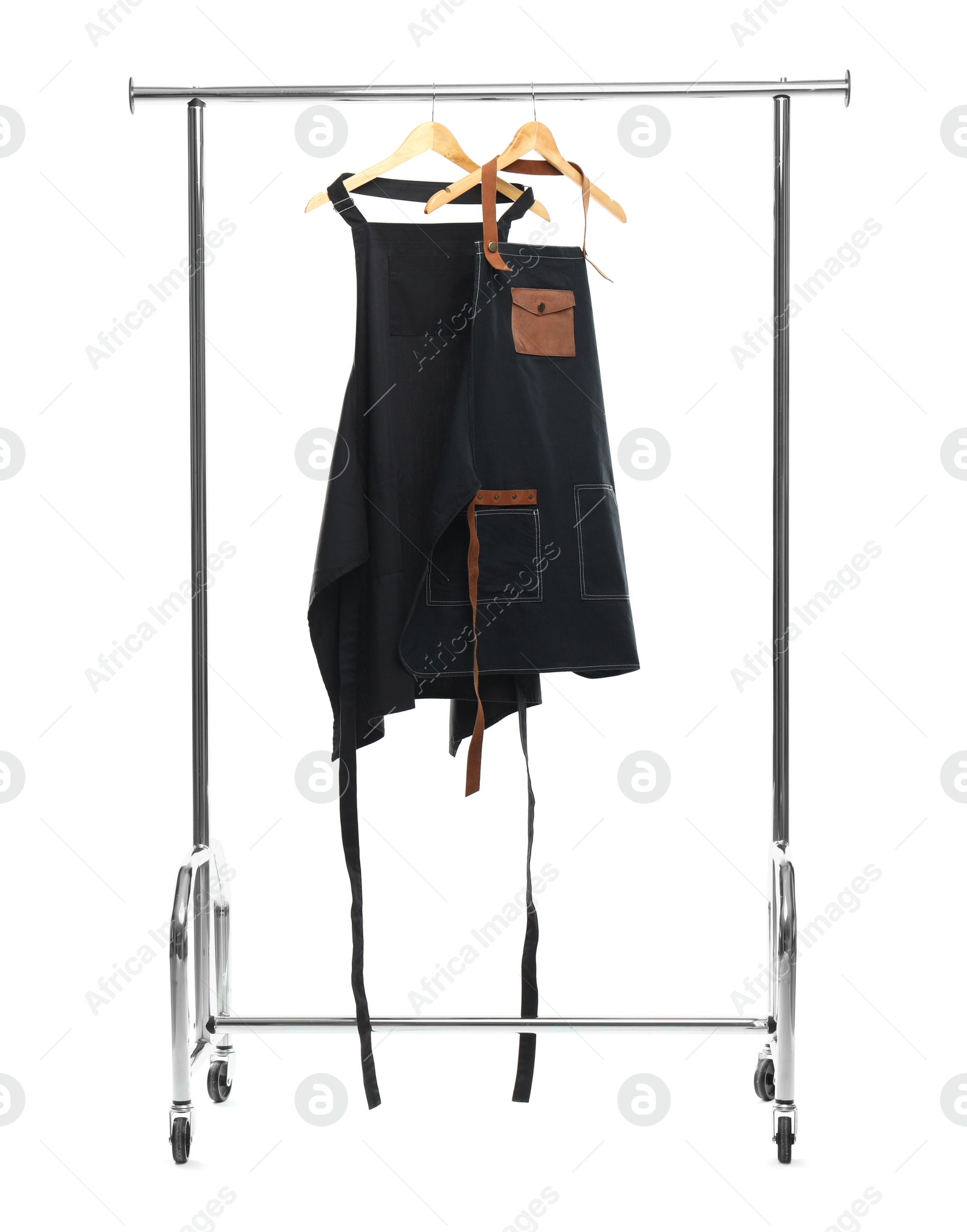 Photo of Two aprons on clothing rack isolated on white