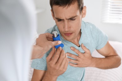 Man getting inhaler at home. Asthma treatment