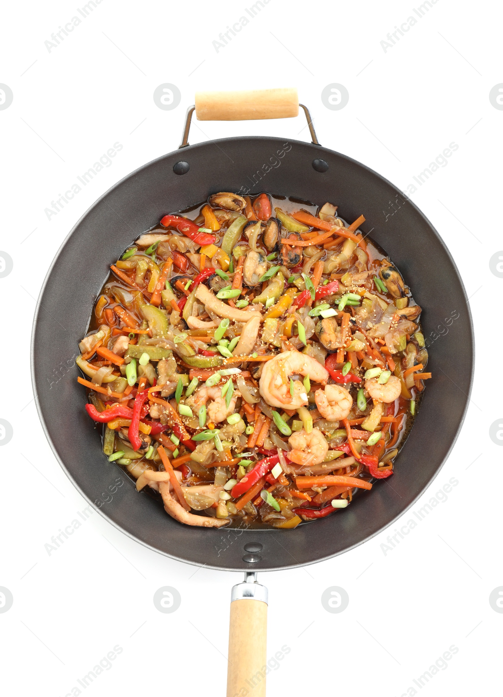 Photo of Stir-fry sea food in wok isolated on white, top view