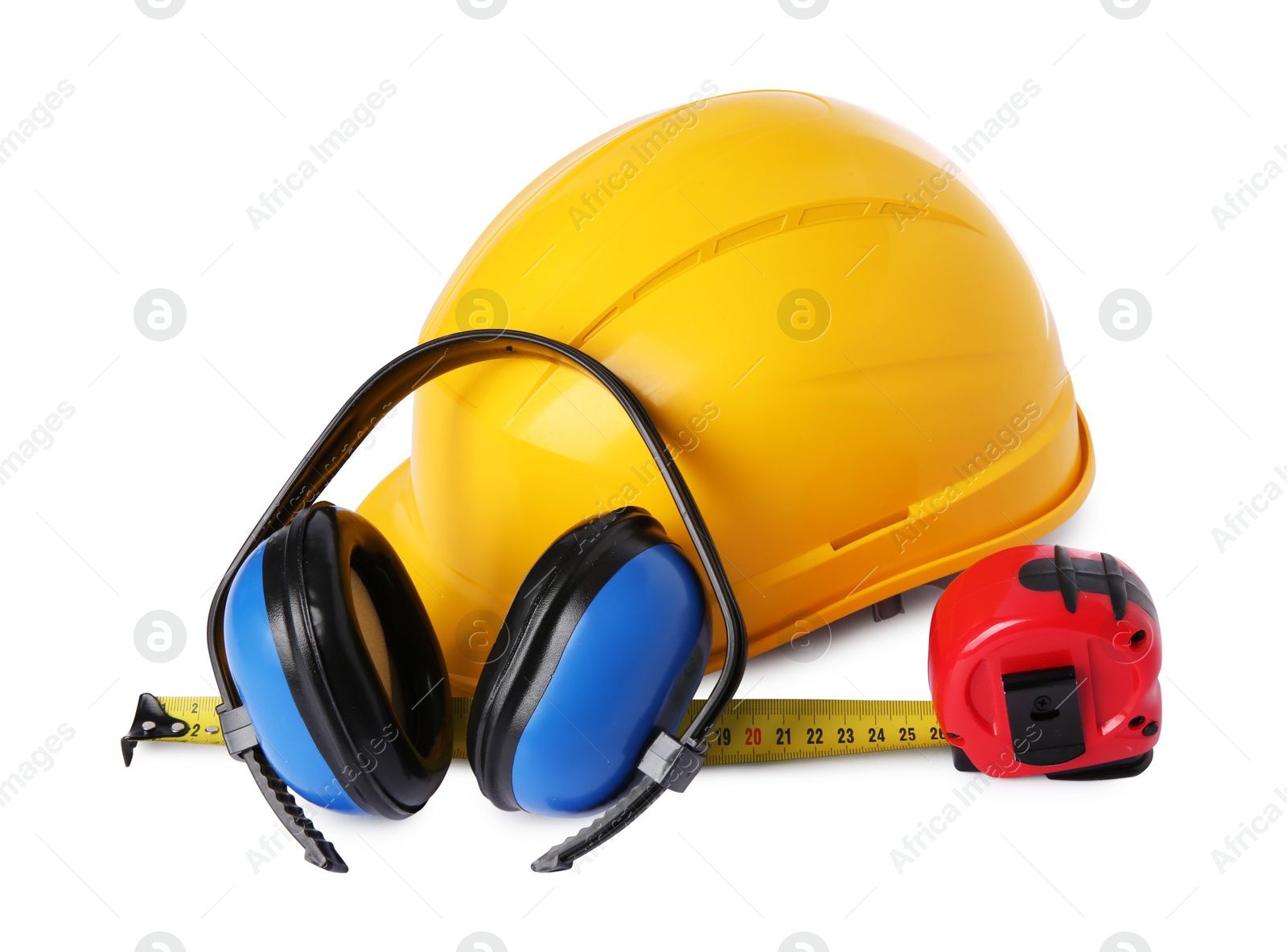 Photo of Yellow hard hat, earmuffs and measuring tape isolated on white. Construction tools