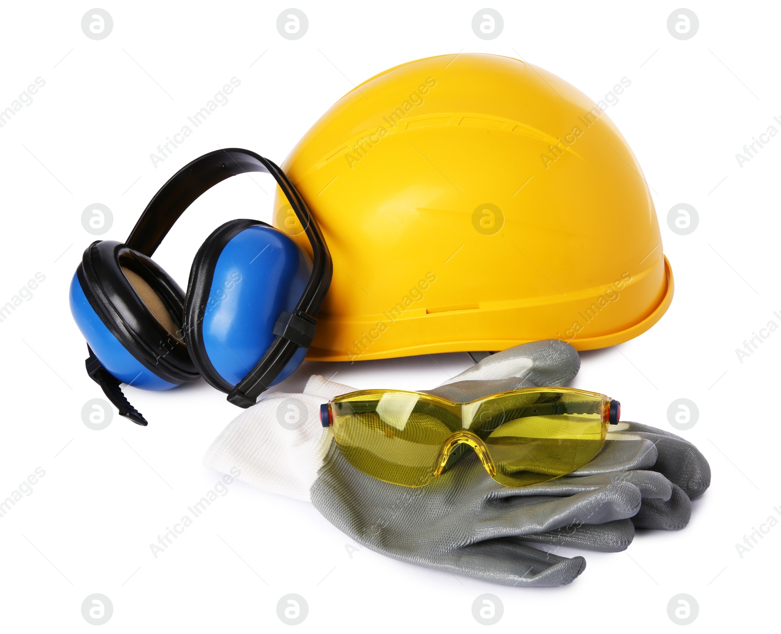 Photo of Yellow hard hat, earmuffs, gloves and goggles isolated on white. Safety equipment