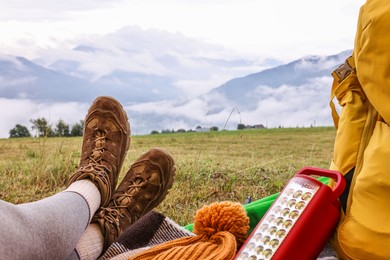 Woman wearing trekking shoes and lying in tent outdoors, closeup