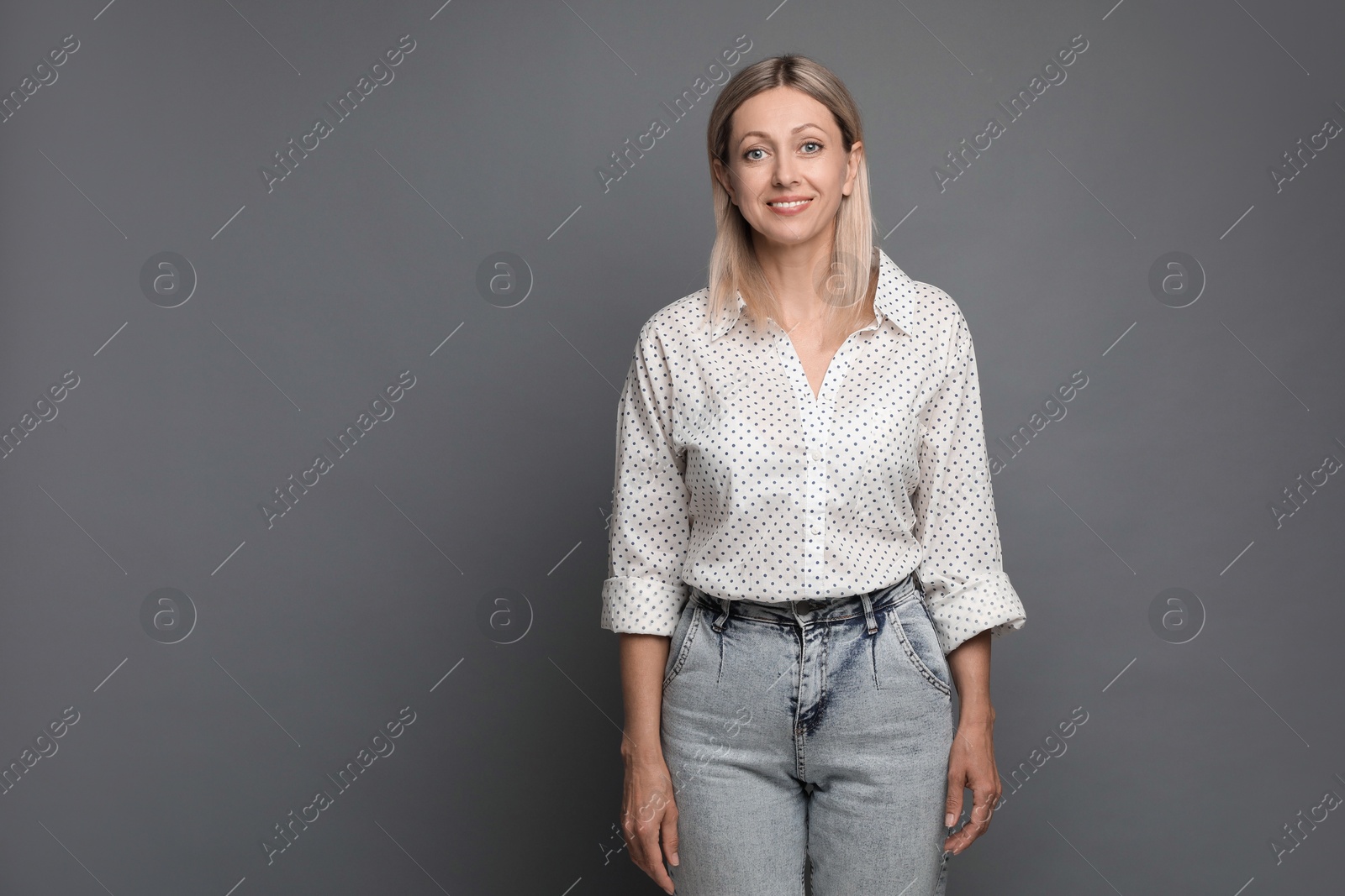 Photo of Portrait of beautiful smiling woman on grey background