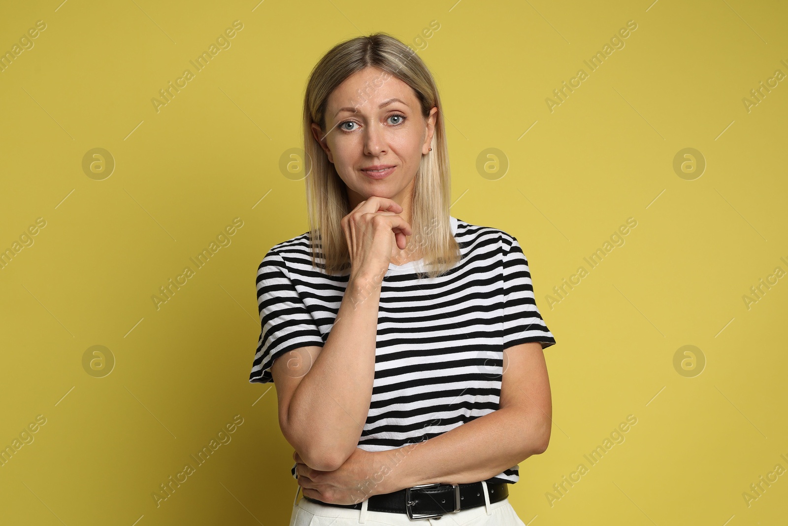 Photo of Portrait of beautiful woman on yellow background