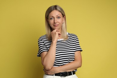 Portrait of beautiful woman on yellow background