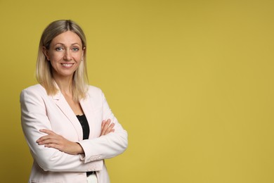 Portrait of beautiful smiling woman on yellow background, space for text