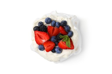 Photo of Pavlova cake (meringue dessert) with whipped cream, fresh berries and mint isolated on white, top view