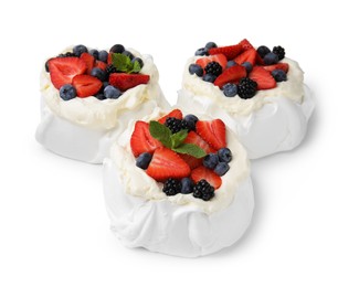 Photo of Pavlova cake (meringue dessert) with whipped cream, fresh berries and mint isolated on white