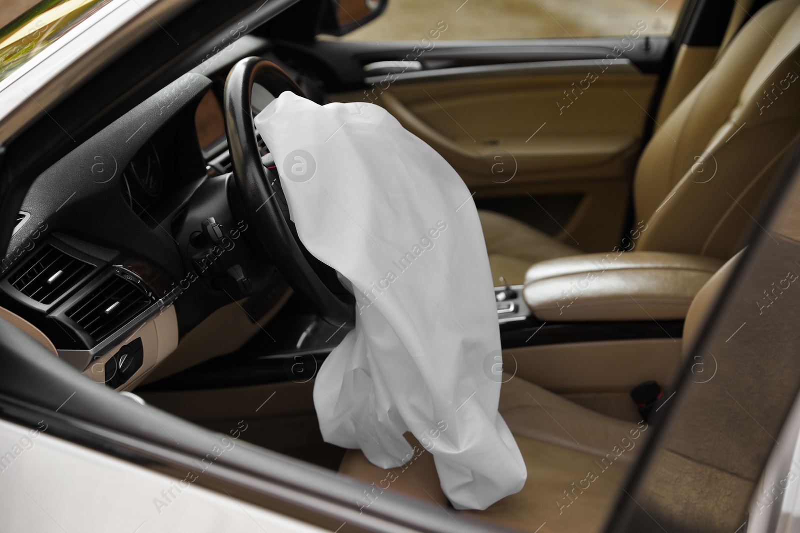 Photo of Opened airbag in automobile. Car safety equipment