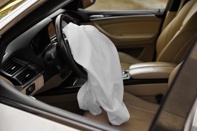 Opened airbag in automobile. Car safety equipment