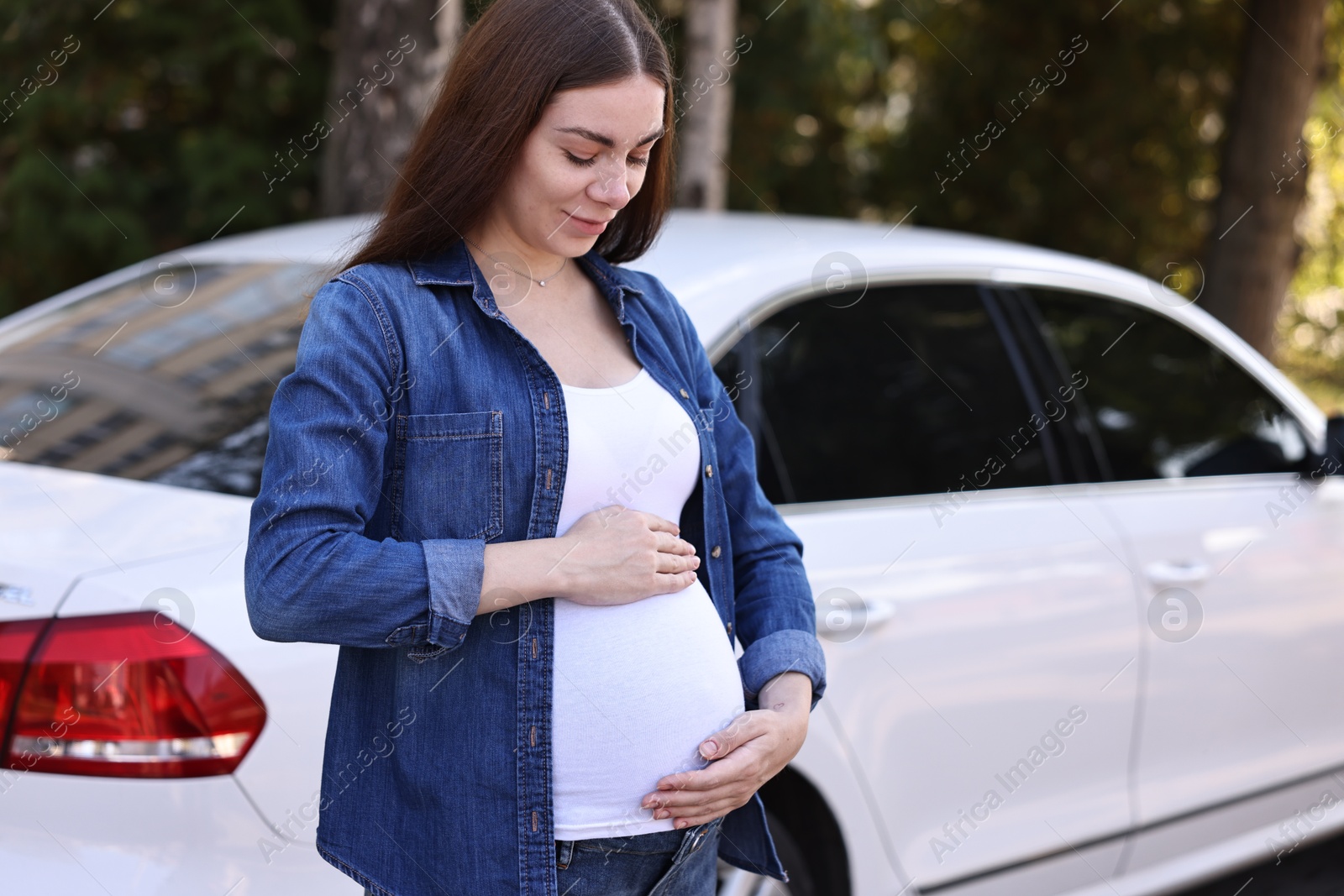 Photo of Portrait of beautiful pregnant woman near car outdoors