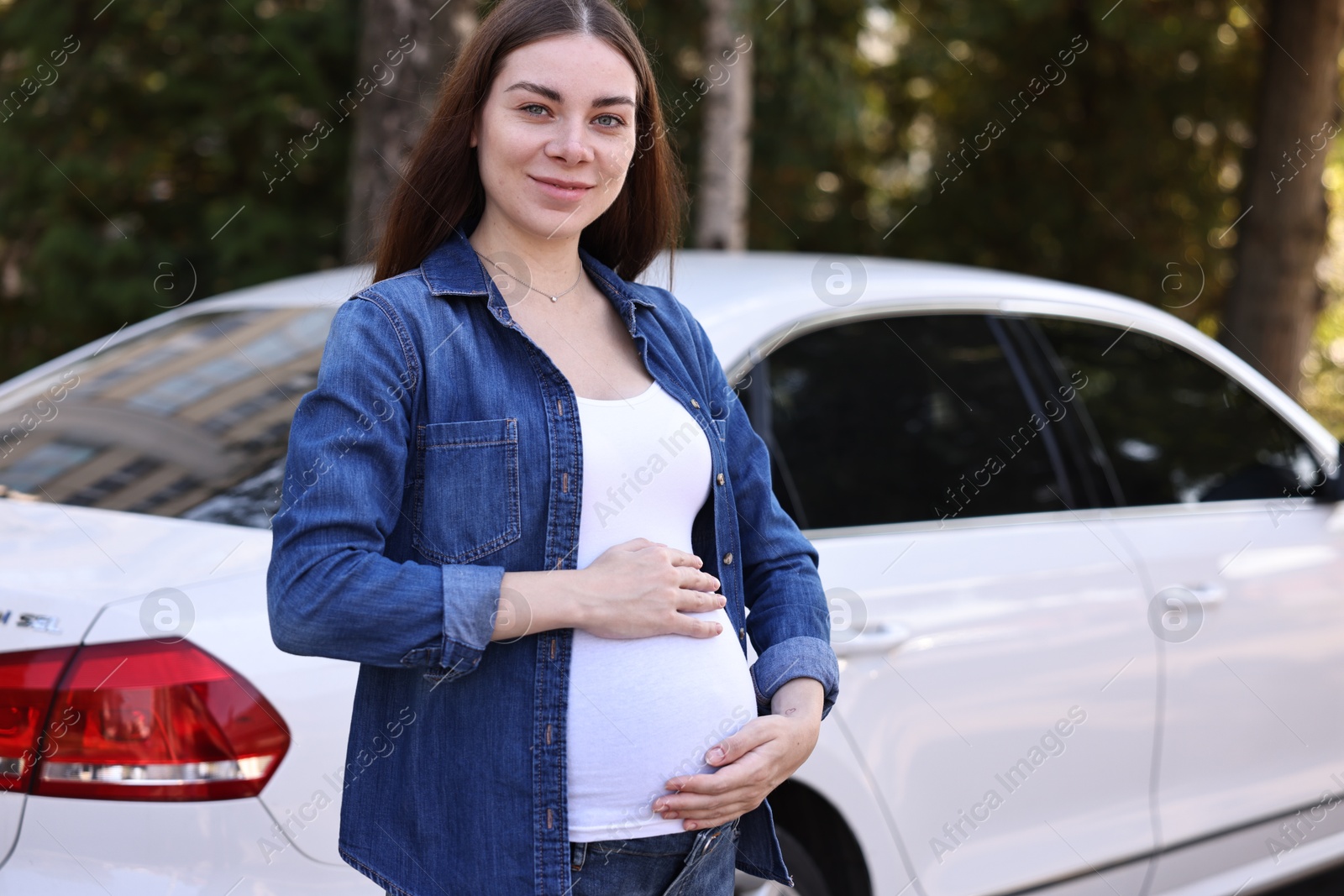 Photo of Portrait of beautiful pregnant woman near car outdoors