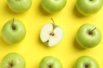 Photo of Flat lay composition with half of apple surrounded by ones on yellow background