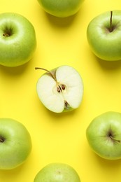 Photo of Flat lay composition with half of apple surrounded by ones on yellow background