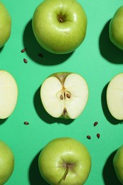 Photo of Flat lay composition with whole, cut apples and seeds on green background