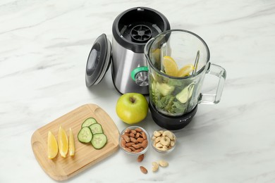 Photo of Modern blender with ingredients for smoothie on white marble table in kitchen