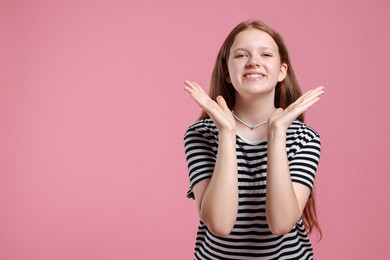 Photo of Portrait of teenage girl on pink background, space for text