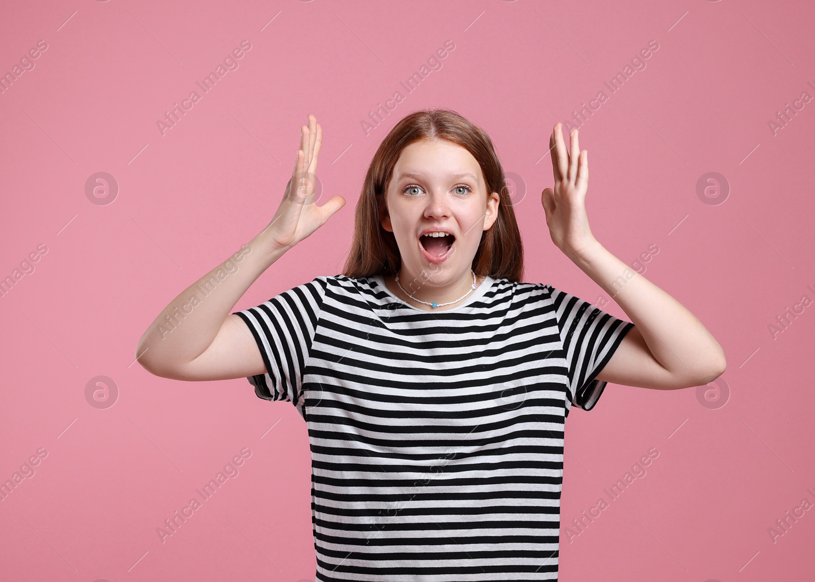 Photo of Portrait of teenage girl on pink background