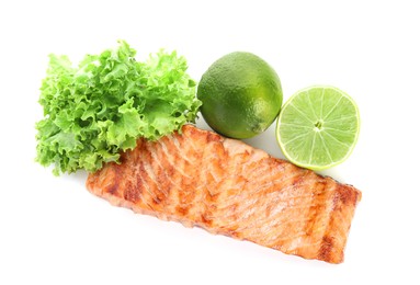 Photo of Delicious grilled salmon fillet with lime and lettuce isolated on white, top view