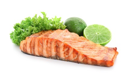 Photo of Delicious grilled salmon fillet with lime and lettuce isolated on white