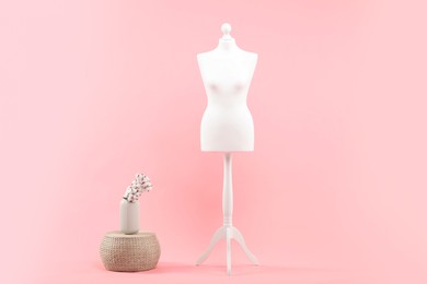 Photo of Mannequin and stylish vase on pink background