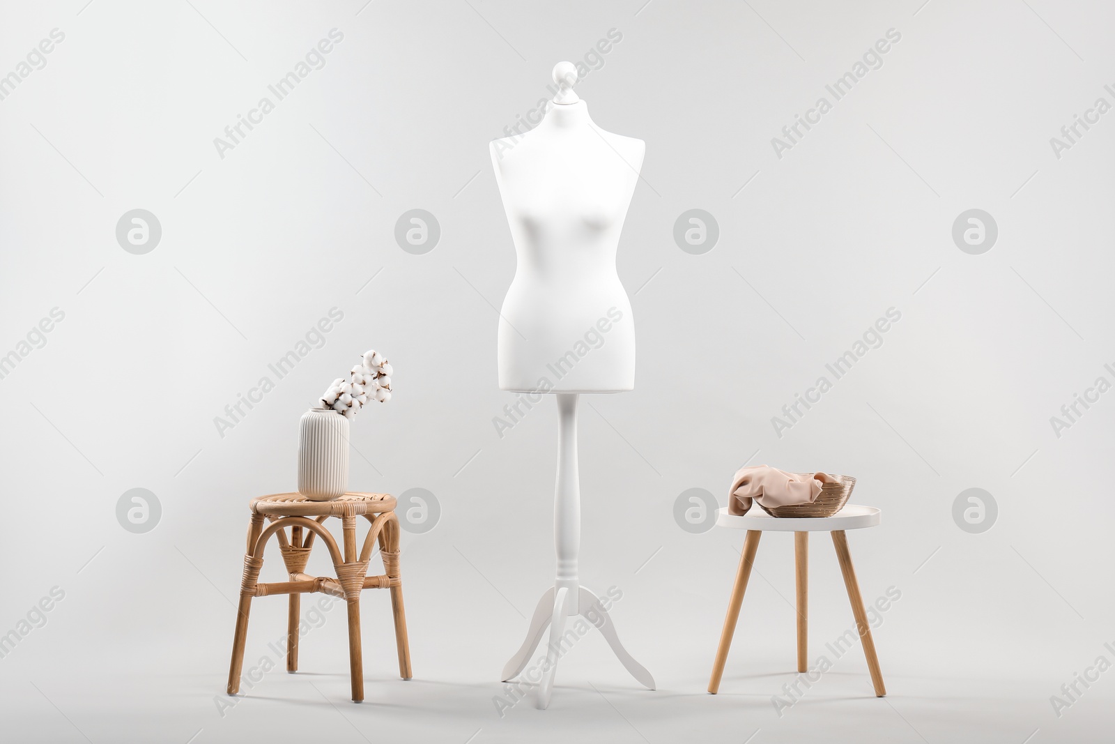 Photo of Mannequin, vase and stools on light grey background