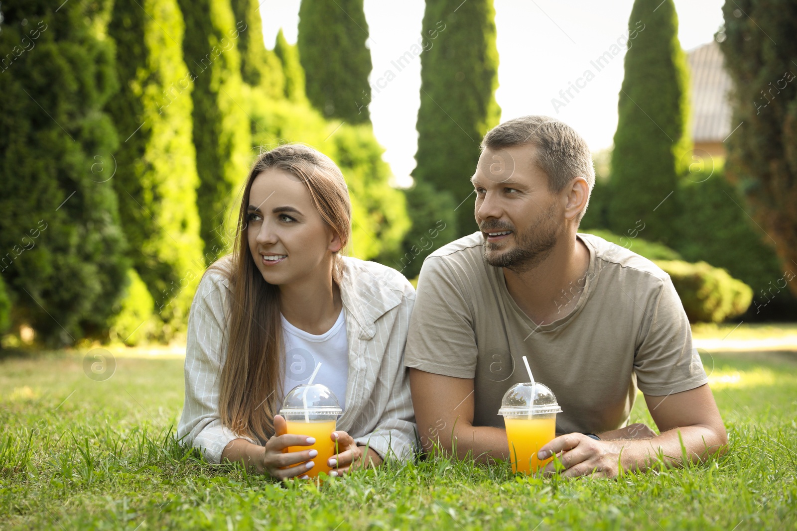 Photo of Couple spending time together on green lawn in park