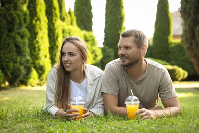 Couple spending time together on green lawn in park