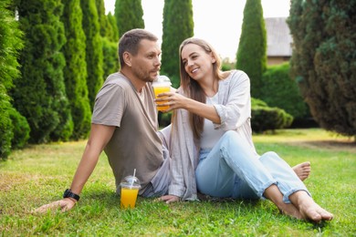 Couple spending time together on green lawn in park