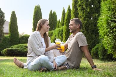 Couple spending time together on green lawn in park