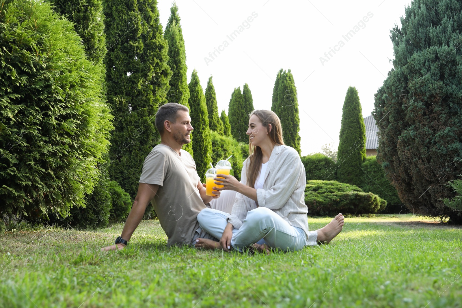 Photo of Couple spending time together on green lawn in park