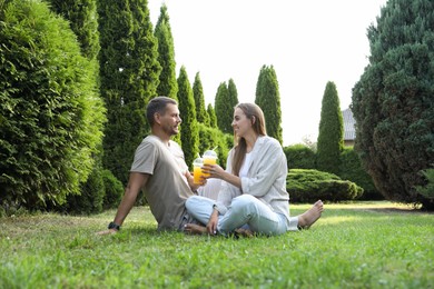 Couple spending time together on green lawn in park