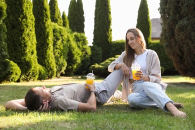 Photo of Couple spending time together on green lawn in park